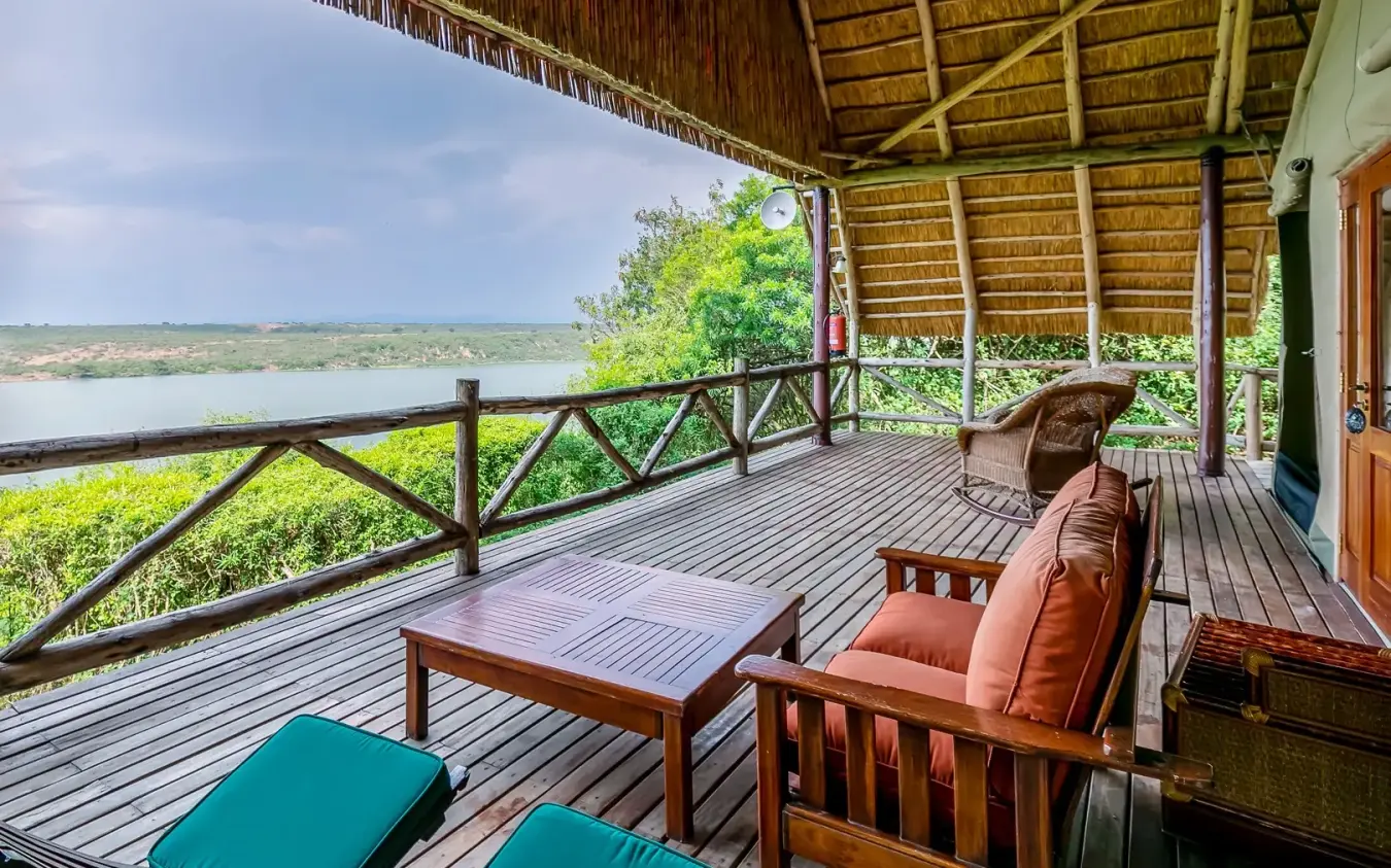 Wooden deck with lounge chairs overlooking water and landscape, Mweya Safari Lodge, Queen Elizabeth NP, Uganda