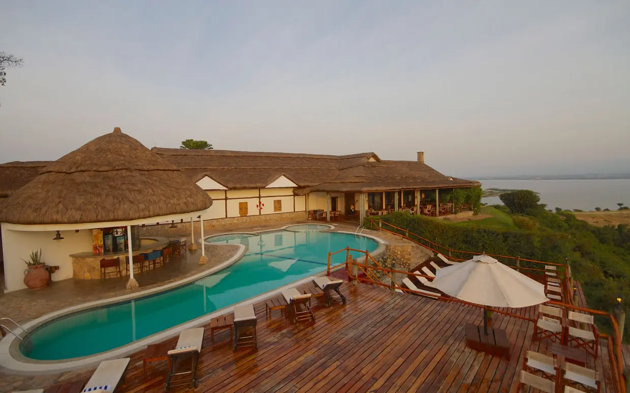 Resort pool deck overlooking lake with lounge chairs, Mweya Safari Lodge, Queen Elizabeth NP, Uganda
