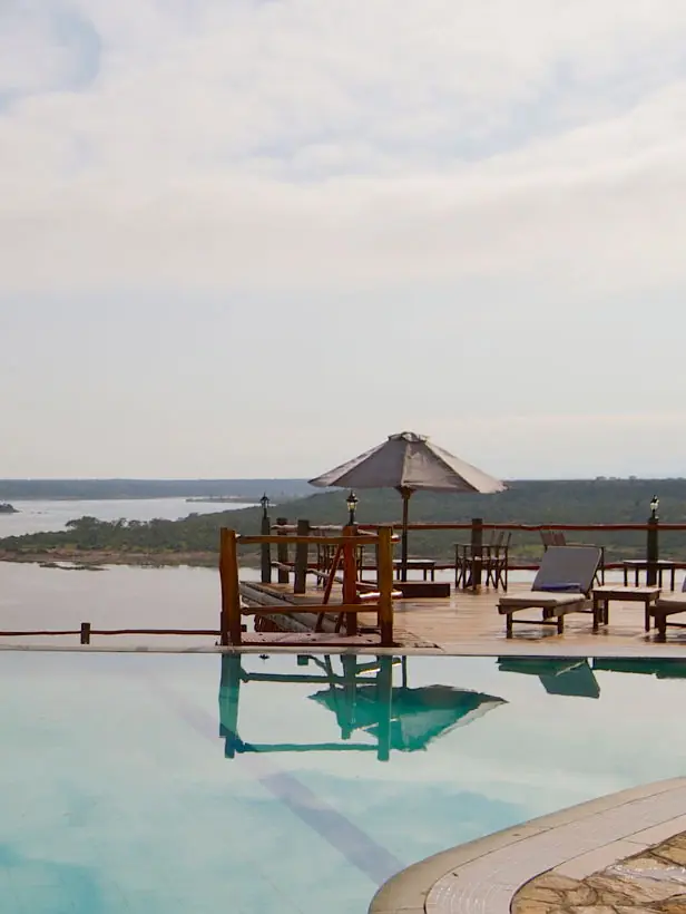 Infinity pool overlooking river with lounge chairs and gazebos, Mweya Safari Lodge, Queen Elizabeth NP, Uganda