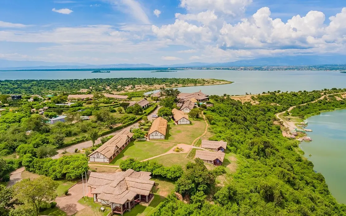 Aerial view of safari lodge buildings surrounded by vegetation and water, Mweya Safari Lodge, Queen Elizabeth NP, Uganda