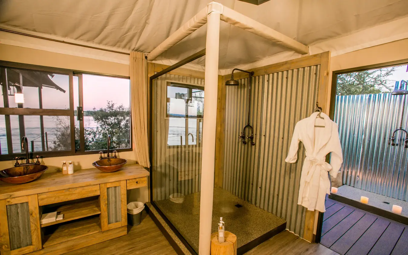 Luxury safari lodge bathroom with canvas ceiling and river view, Old Drift Lodge, Victoria Falls, Zimbabwe
