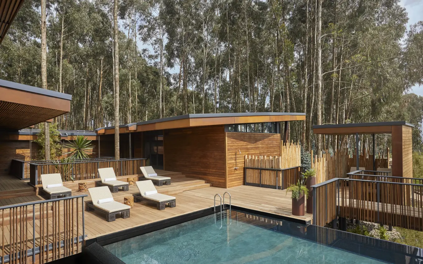 Swimming pool with lounge chairs and wooden structures, Gorilla’s Nest, Volcanoes National Park, Rwanda