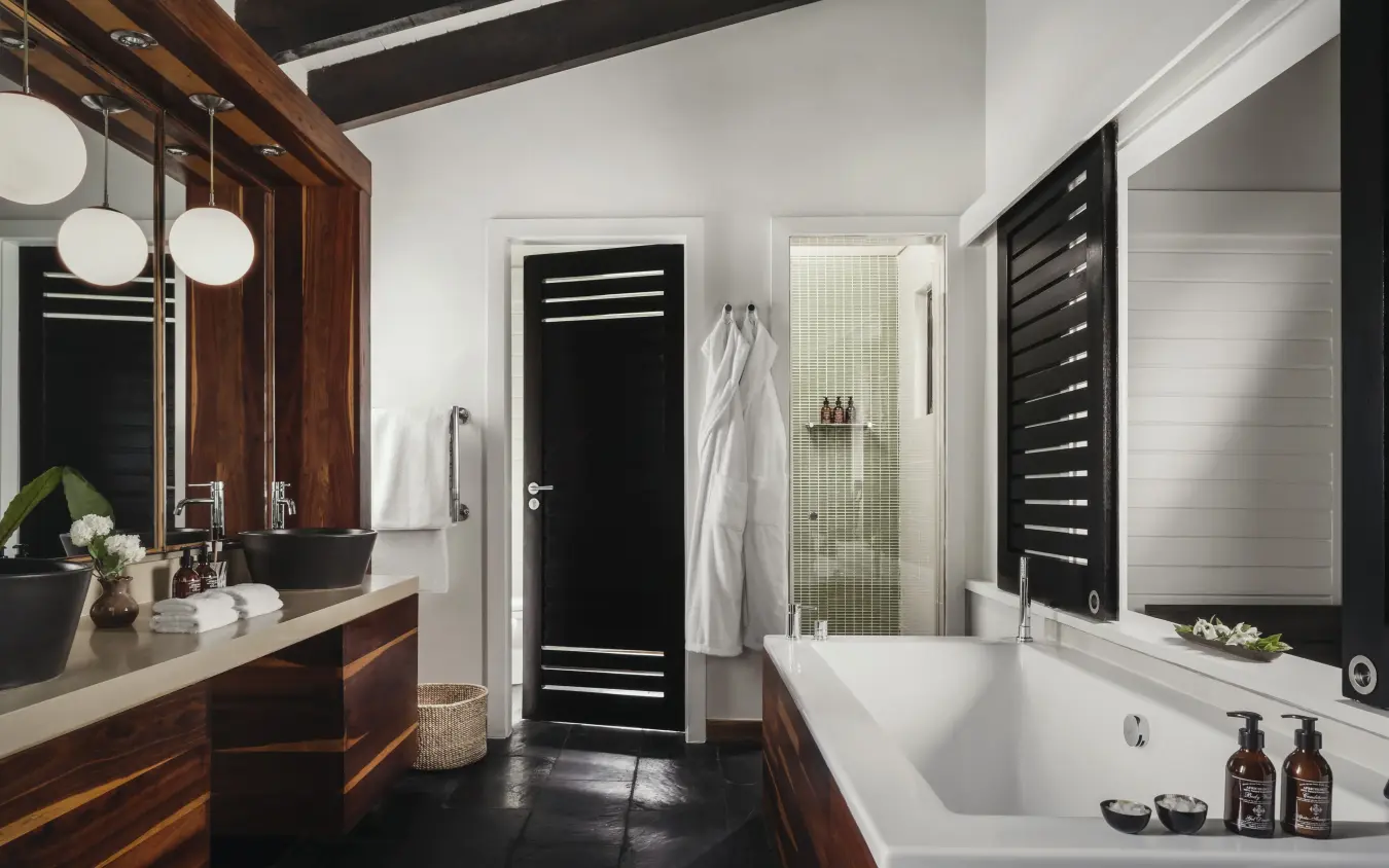 Luxury bathroom with wooden vanity and white soaking tub, Nyungwe House, Nyungwe Forest, Rwanda