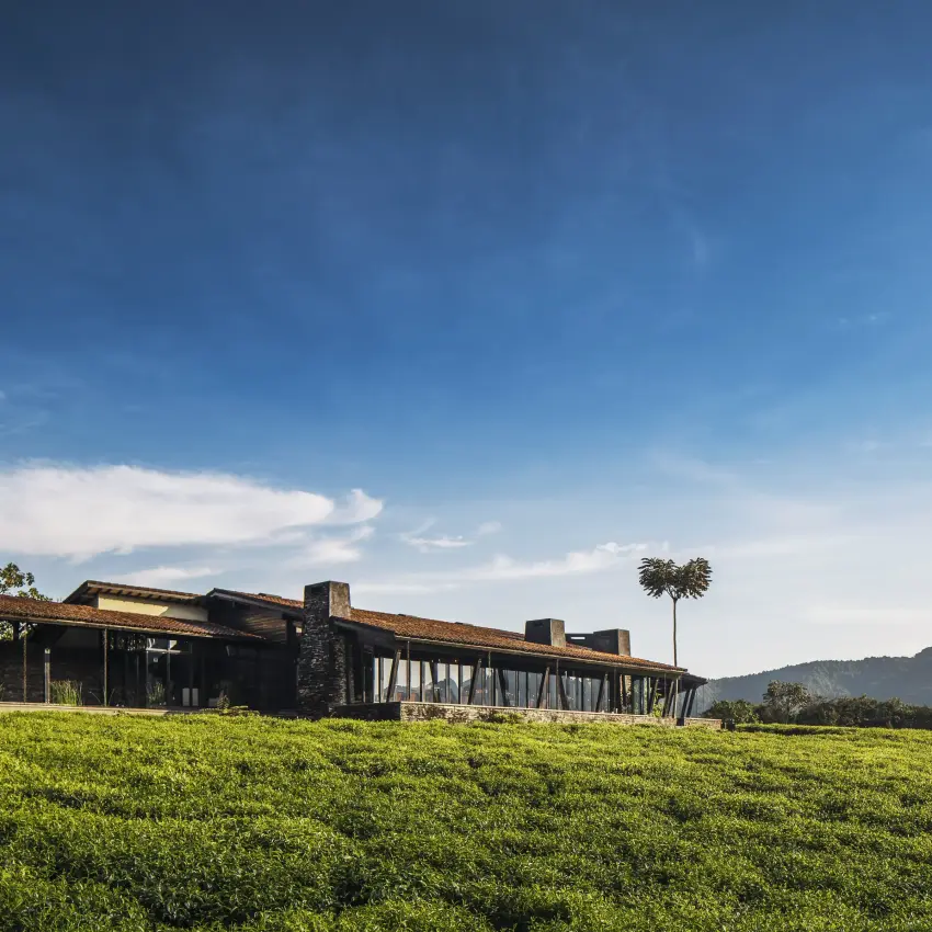 Modern lodge building set in expansive green valley landscape, Nyungwe House, Nyungwe Forest, Rwanda