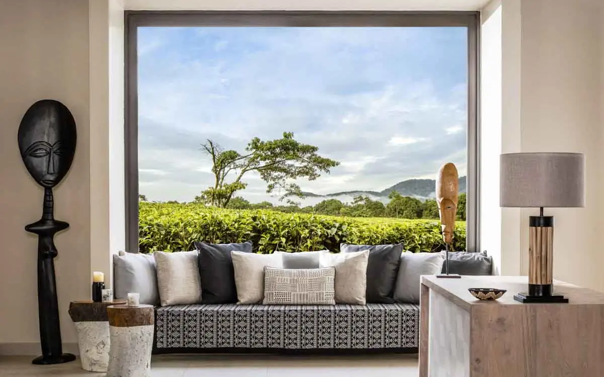 Modern lounge with large window overlooking tea plantations, Nyungwe House, Nyungwe Forest, Rwanda