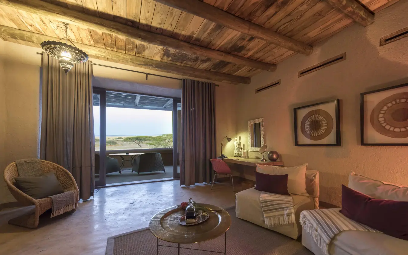 Modern lounge with views across savanna landscape, Onguma The Fort, Etosha National Park, Namibia