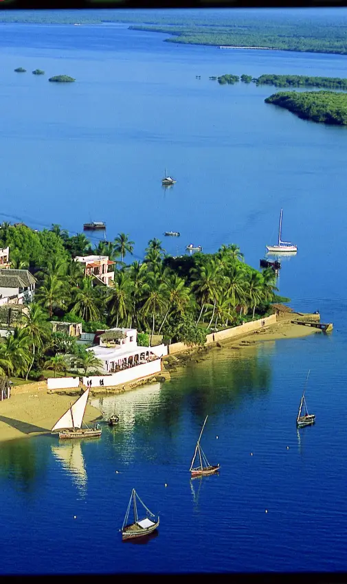 Coastal settlement with sailboats anchored in turquoise waters, Peponi Hotel, Lamu Archipelago, Kenya