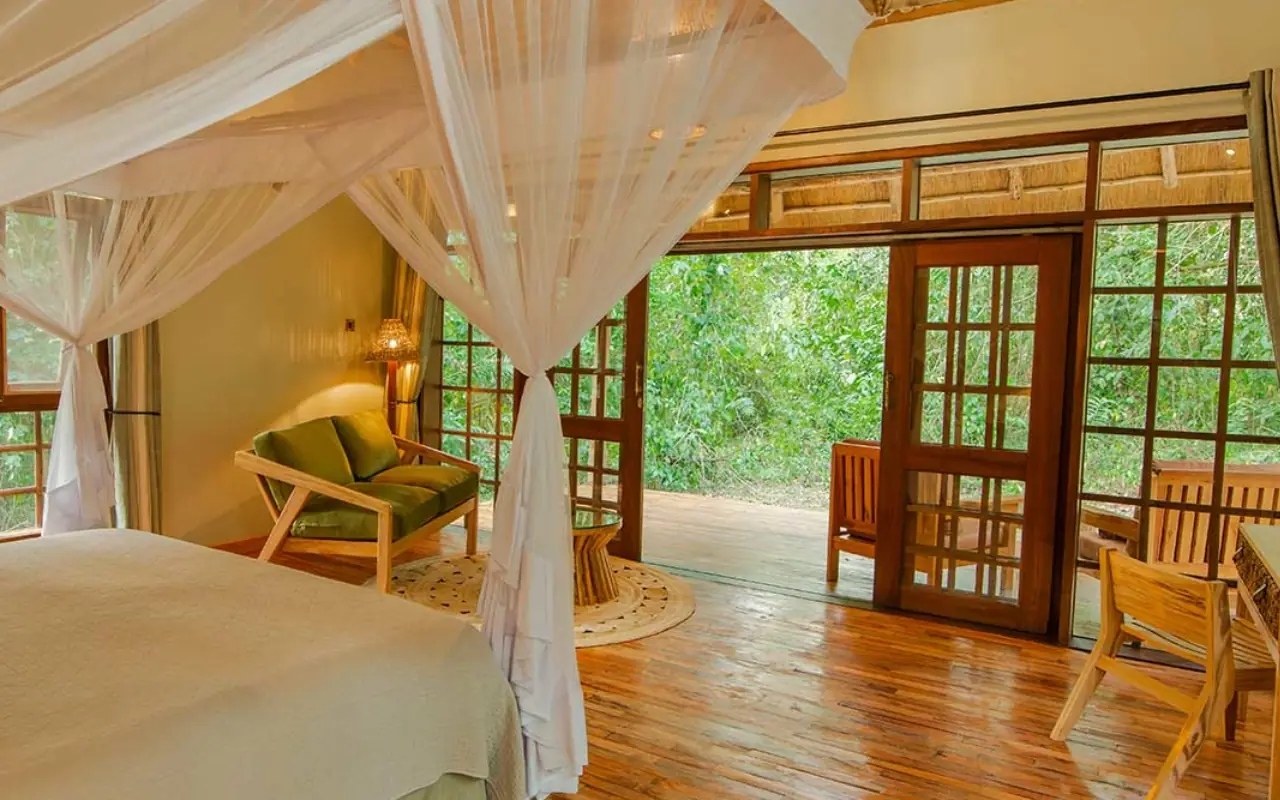 Spacious bedroom with canopy bed and forest views, Primate Lodge, Kibale Forest, Uganda