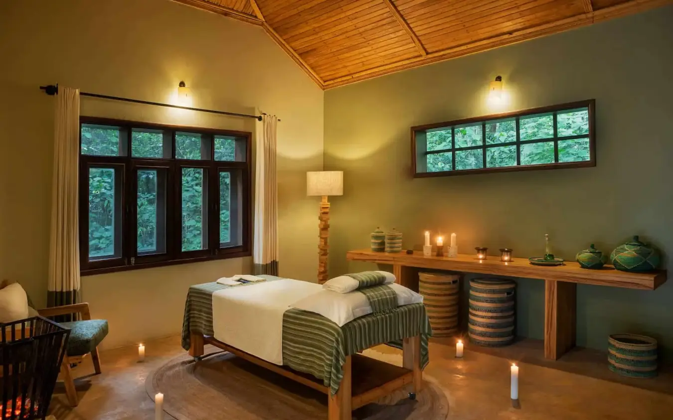 Spa treatment room with massage bed and candlelight, Primate Lodge, Kibale Forest, Uganda
