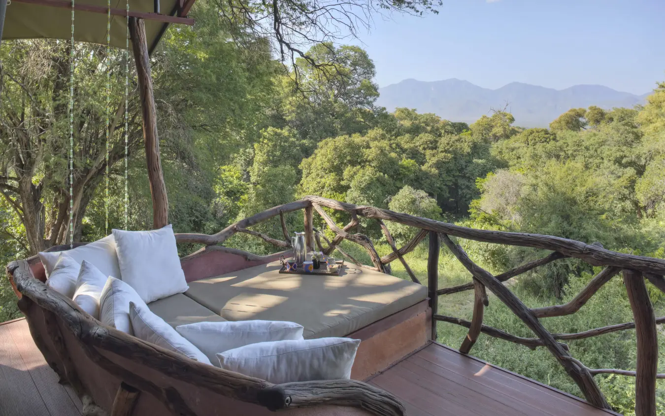 Tree house deck with lounge bed overlooking forested valley, Sarara Treehouses, Northern Kenya, Kenya