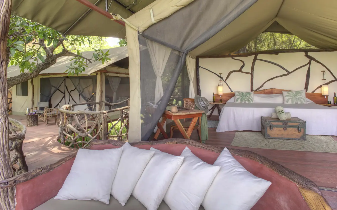 Canvas tent bedroom with four-poster bed and seating area, Sarara Treehouses, Northern Kenya, Kenya