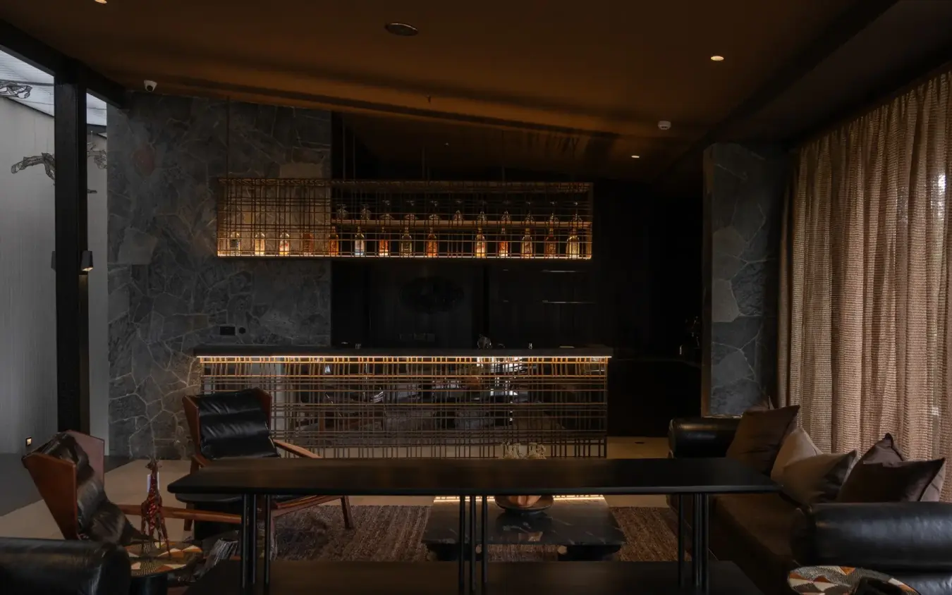 Modern lounge with dark marble walls and geometric lighting, Silverback Lodge, Bwindi Impenetrable Forest, Uganda