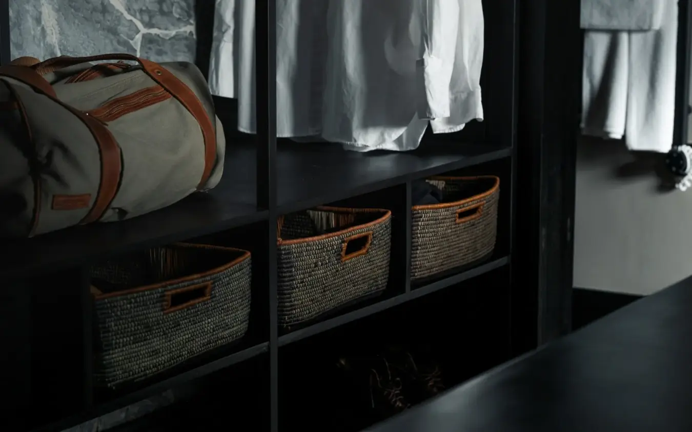 Wardrobe storage with woven baskets and hanging clothes, Silverback Lodge, Bwindi Impenetrable Forest, Uganda