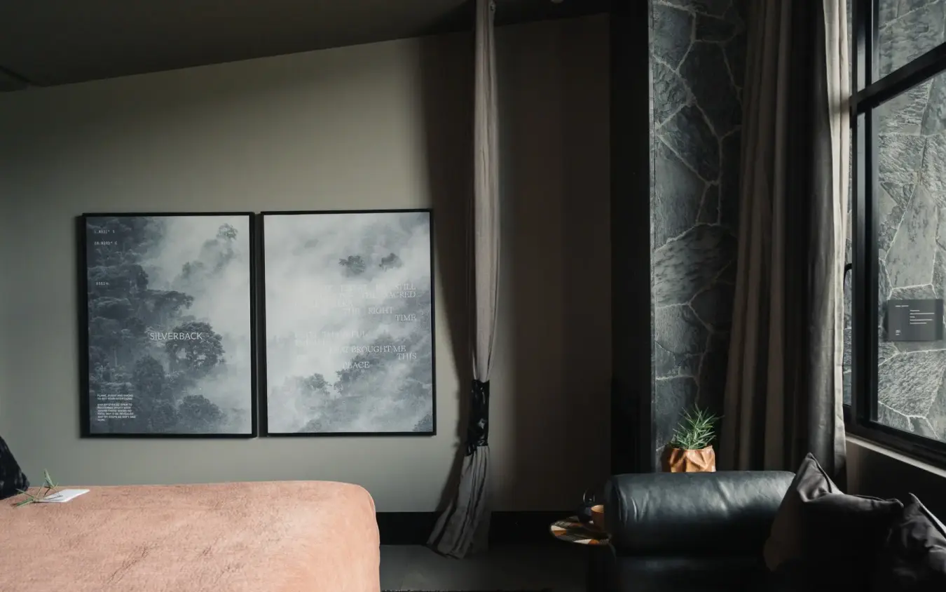 Modern bedroom with framed artwork and large windows, Silverback Lodge, Bwindi Impenetrable Forest, Uganda
