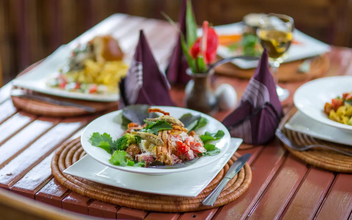 Plated dish with vegetables and fresh herbs at table setting, Hemingways Retreat Kigali, Kigali, Rwanda