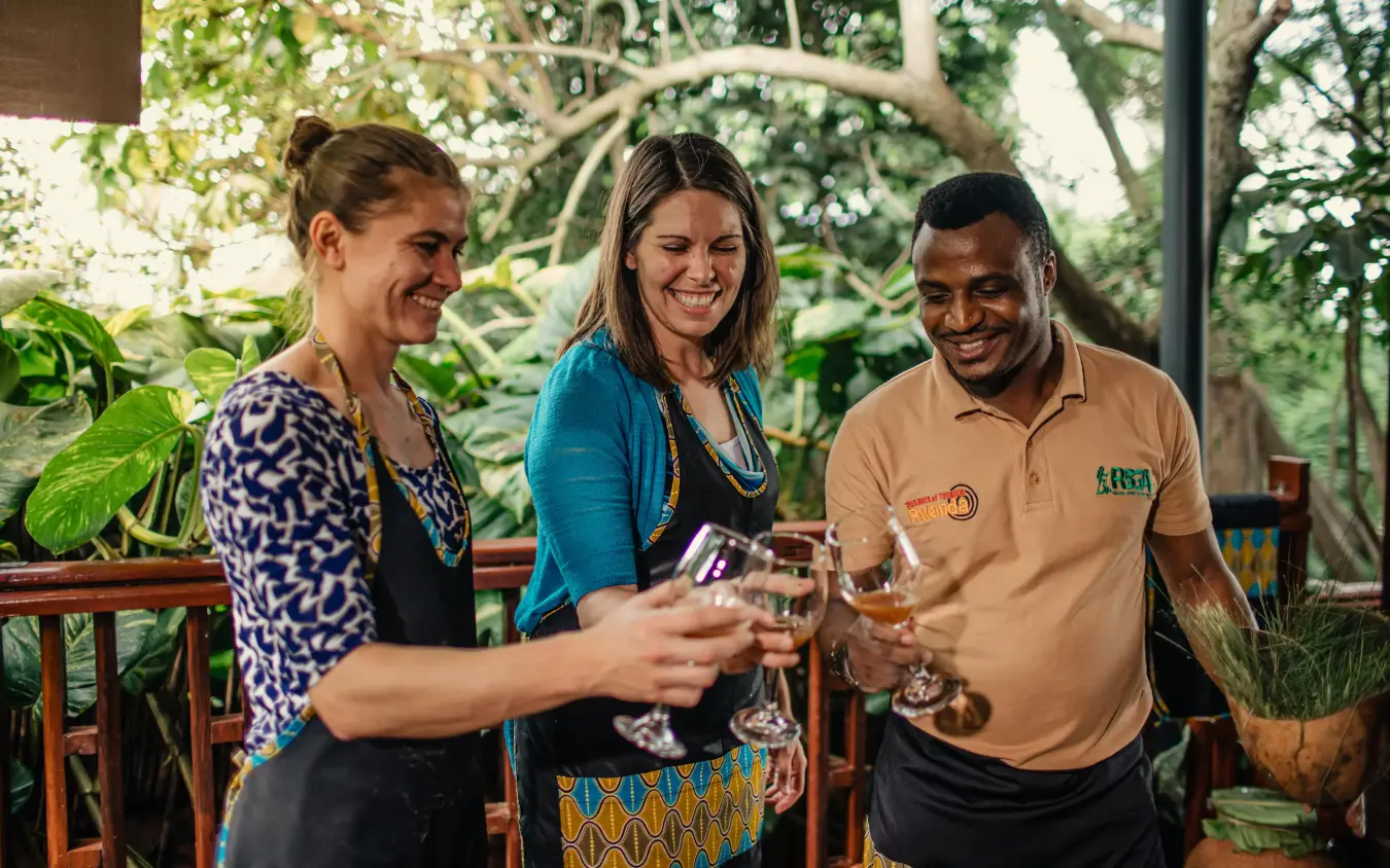 Three people toasting with drinks in lush garden setting, Hemingways Retreat Kigali, Kigali, Rwanda