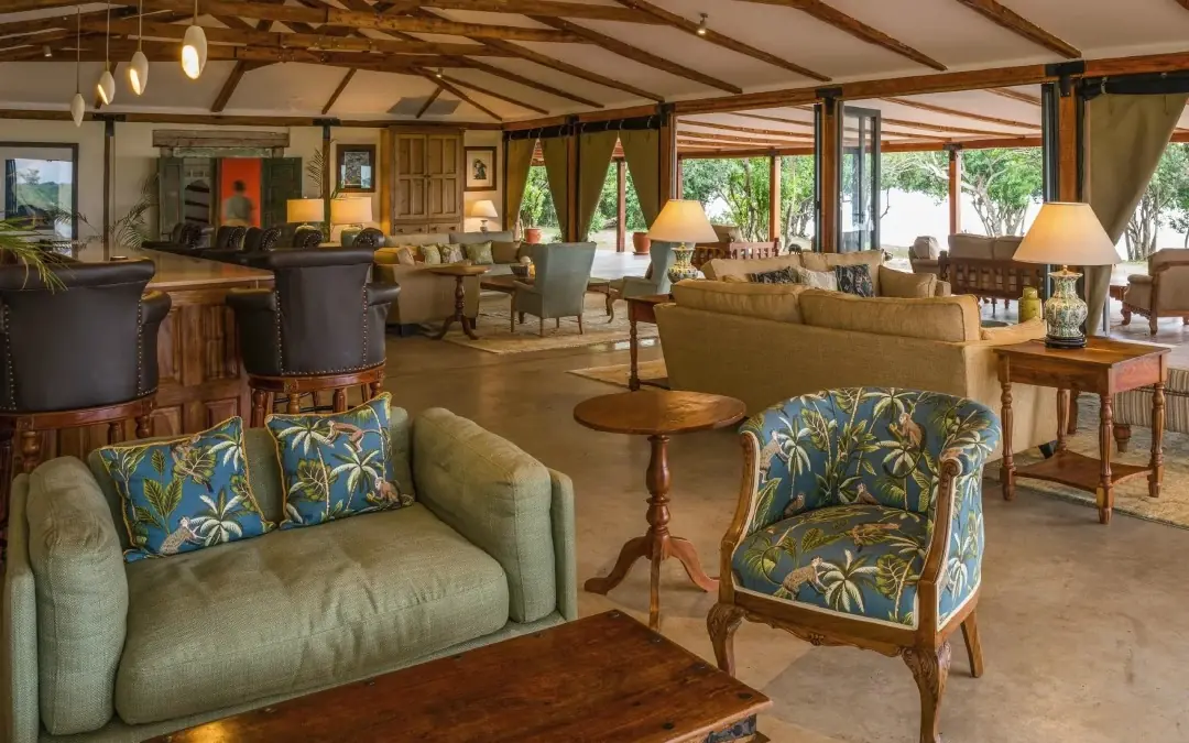 Open-plan lounge with wooden beams and natural light, The River Station, Queen Elizabeth NP, Uganda