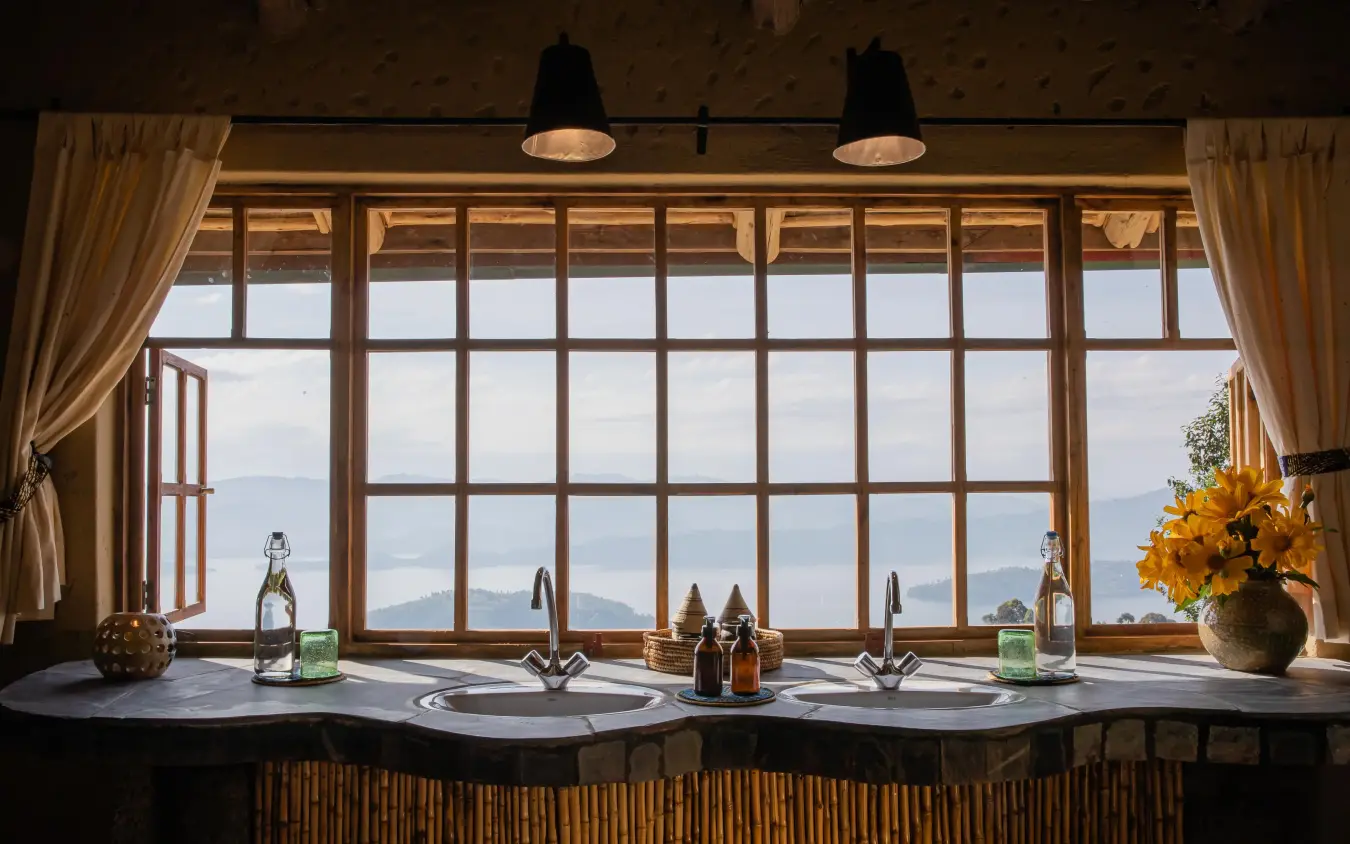 Dual sink bathroom with expansive mountain view windows, Virunga Lodge, Volcanoes National Park, Rwanda