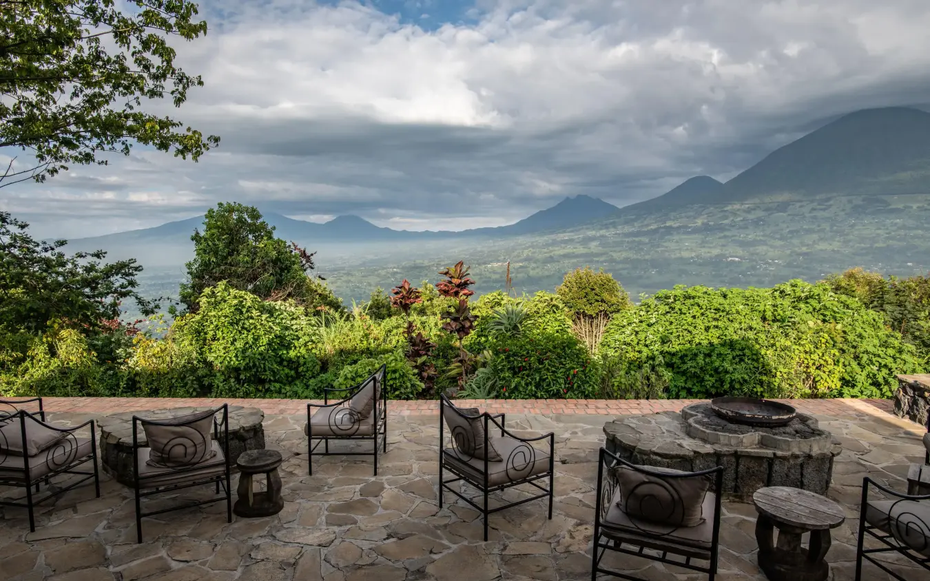 Stone terrace with seating overlooking volcanic mountains, Virunga Lodge, Volcanoes National Park, Rwanda