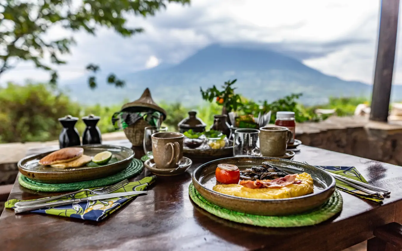 Breakfast table setting with mountain view in background, Virunga Lodge, Volcanoes National Park, Rwanda