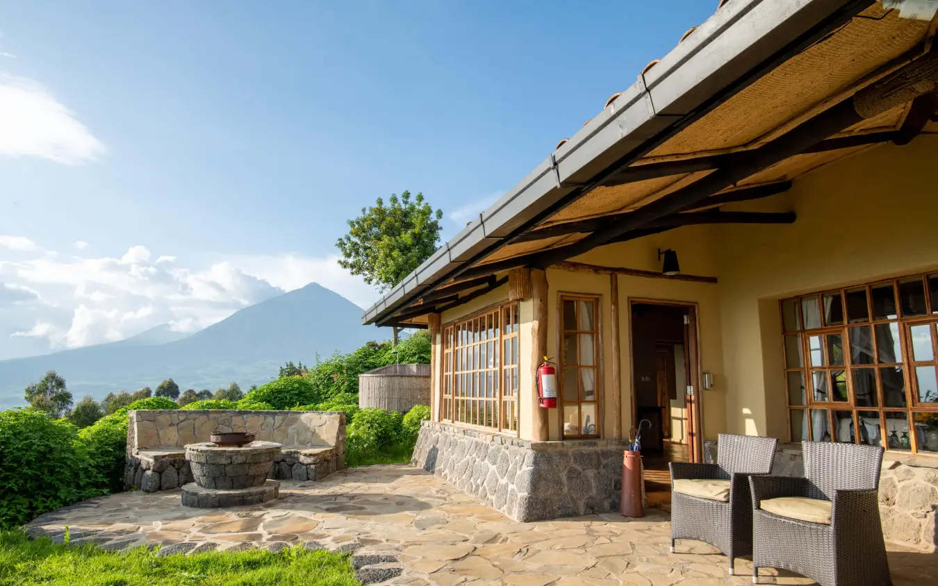 Stone lodge building with mountain vista in background, Virunga Lodge, Volcanoes National Park, Rwanda