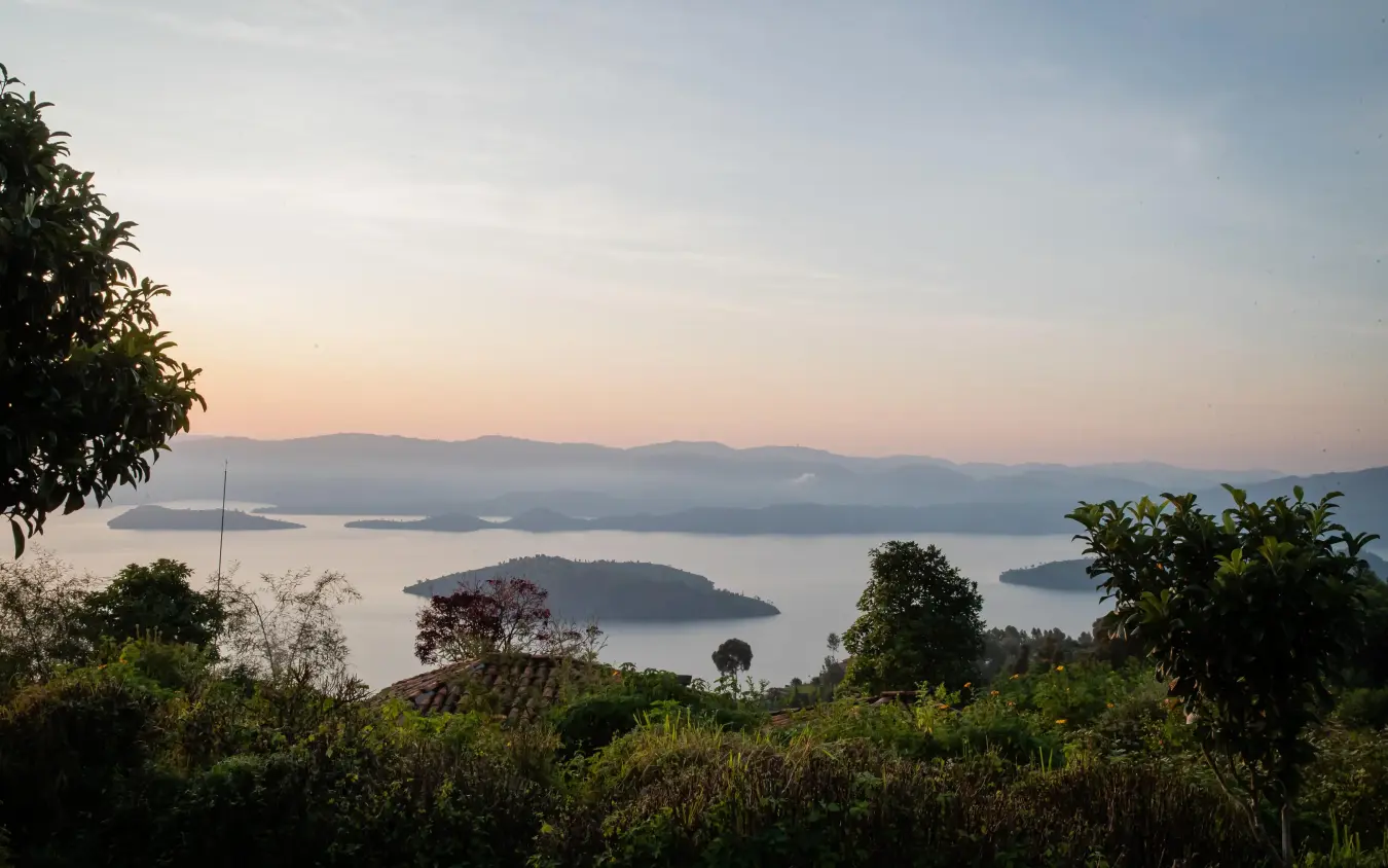 Lake view at sunrise with forested islands and mountains, Virunga Lodge, Volcanoes National Park, Rwanda