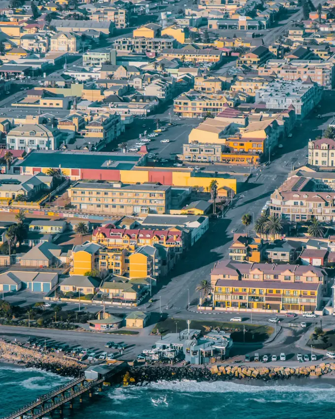 Coastal town with colorful buildings and beach waves