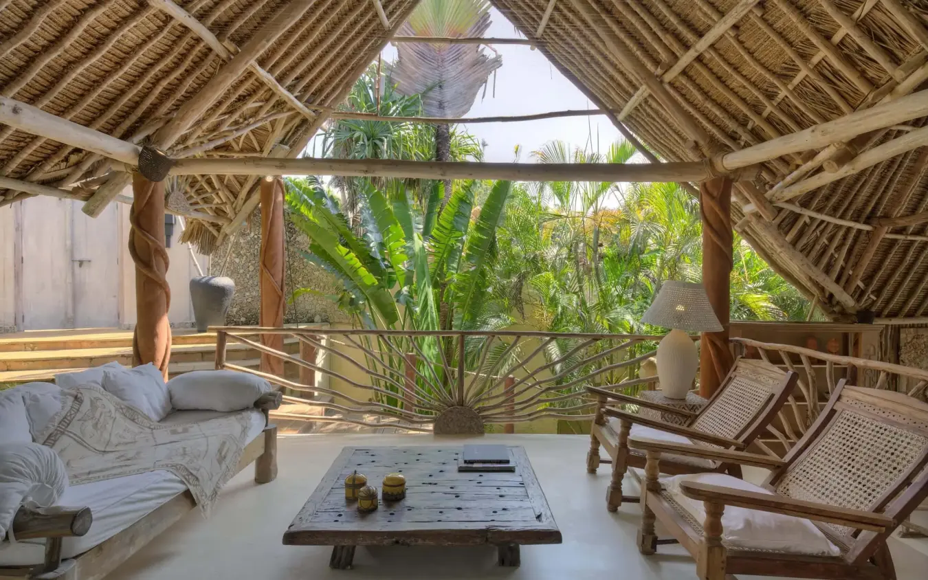 Open-air bedroom pavilion with thatched roof overlooking tropical garden, Alfajiri Beach Villa, Diani Beach, Kenya