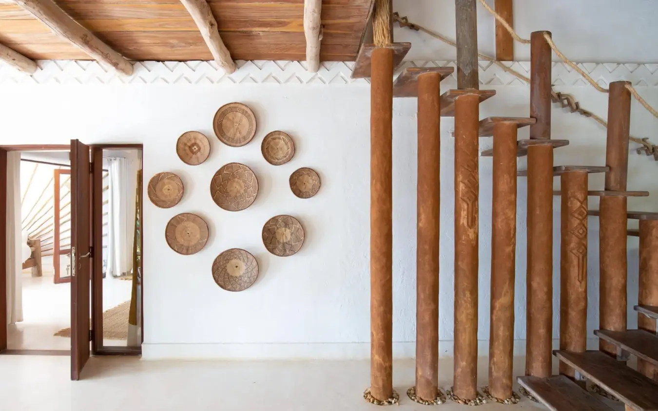 Rustic interior with woven basket wall display and wooden structural beams, Alfajiri Beach Villa, Diani Beach, Kenya