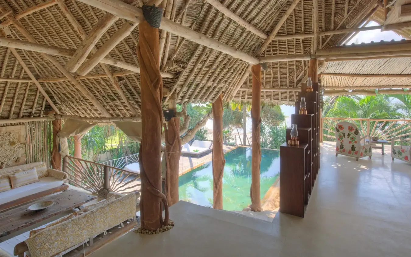 Open-sided thatch pavilion with timber posts overlooking lagoon and gardens, Alfajiri Beach Villa, Diani Beach, Kenya