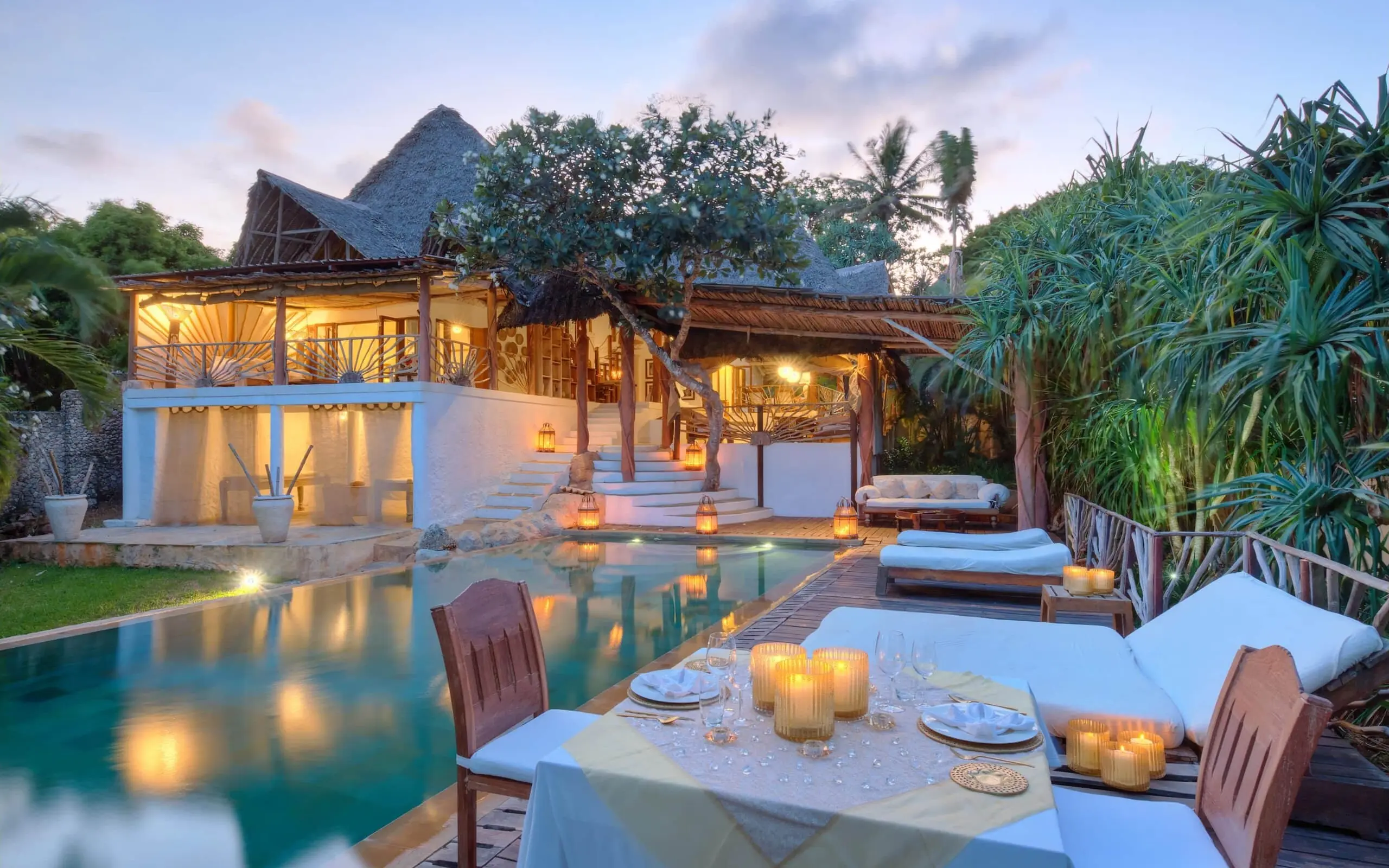 Luxury villa with infinity pool and dining area at dusk, Alfajiri Beach Villa, Diani Beach, Kenya