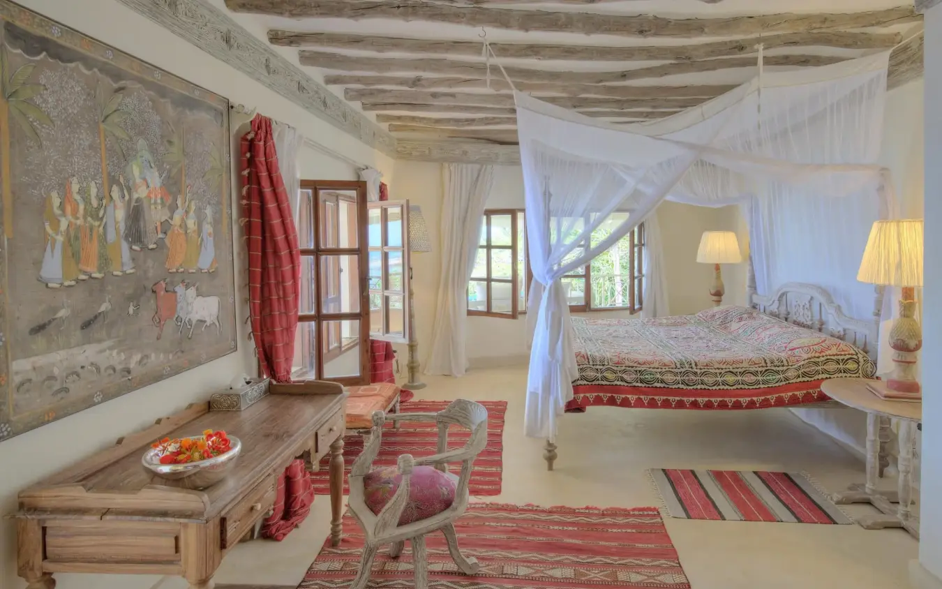 Bedroom with canopy bed and traditional textiles in lodge interior, Alfajiri Cliff Villa, Diani Beach, Kenya