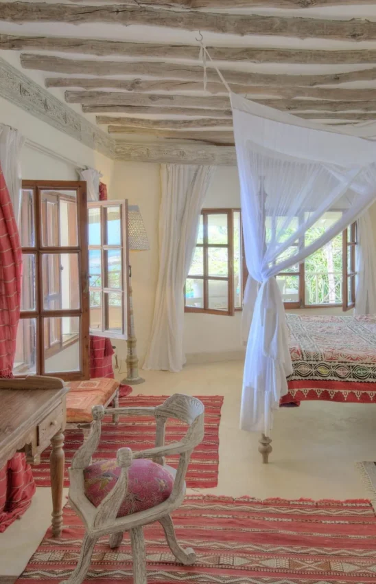 Bedroom with exposed beam ceiling and sheer canopy drapes over twin beds, Alfajiri Cliff Villa, Diani Beach, Kenya
