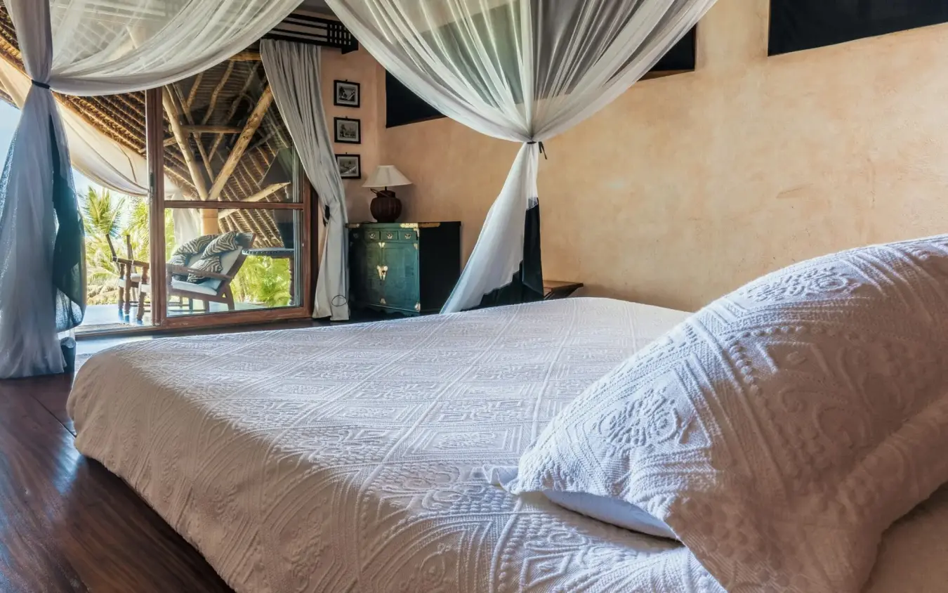 Bedroom with draped canopy bed and open-air wooden pavilion view, Alfajiri Garden Villa, Diani Beach, Kenya