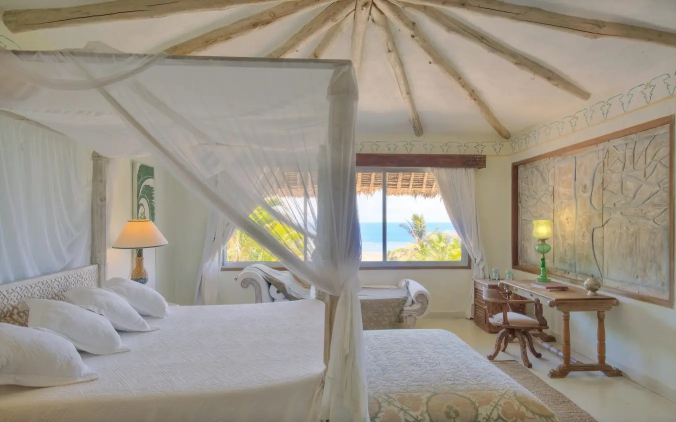 Luxury bedroom with canopy beds overlooking ocean coastline, Alfajiri Garden Villa, Diani Beach, Kenya