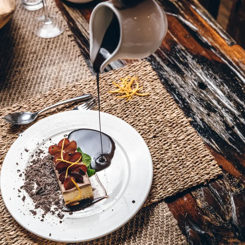 Plated dessert with chocolate, berries and sauce drizzle, Amakoro Songa Lodge, Volcanoes National Park, Rwanda