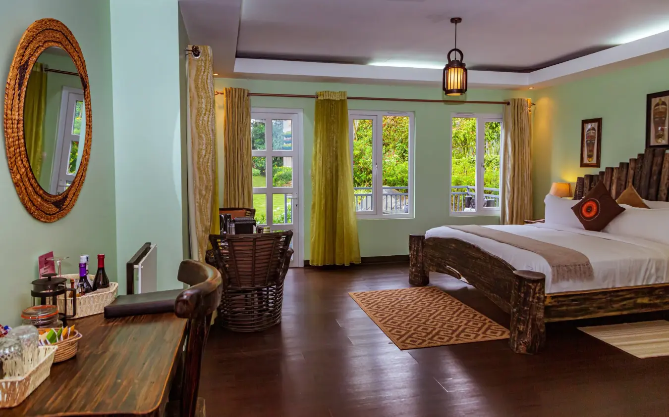 Spacious bedroom with wooden bed and garden views, Amakoro Songa Lodge, Volcanoes National Park, Rwanda