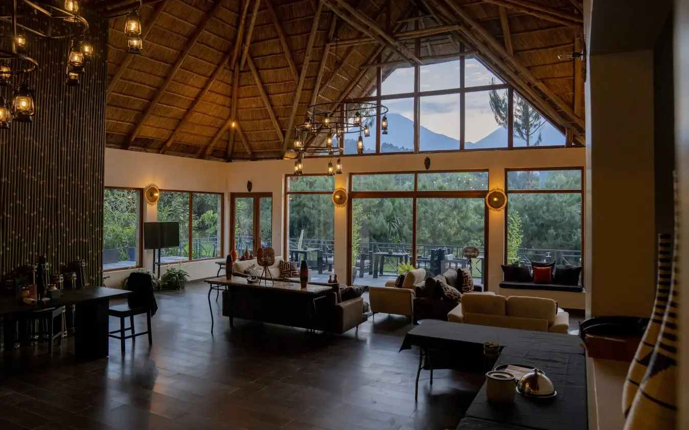 Open-plan lodge interior with mountain views through large windows, Amakoro Songa Lodge, Volcanoes National Park, Rwanda