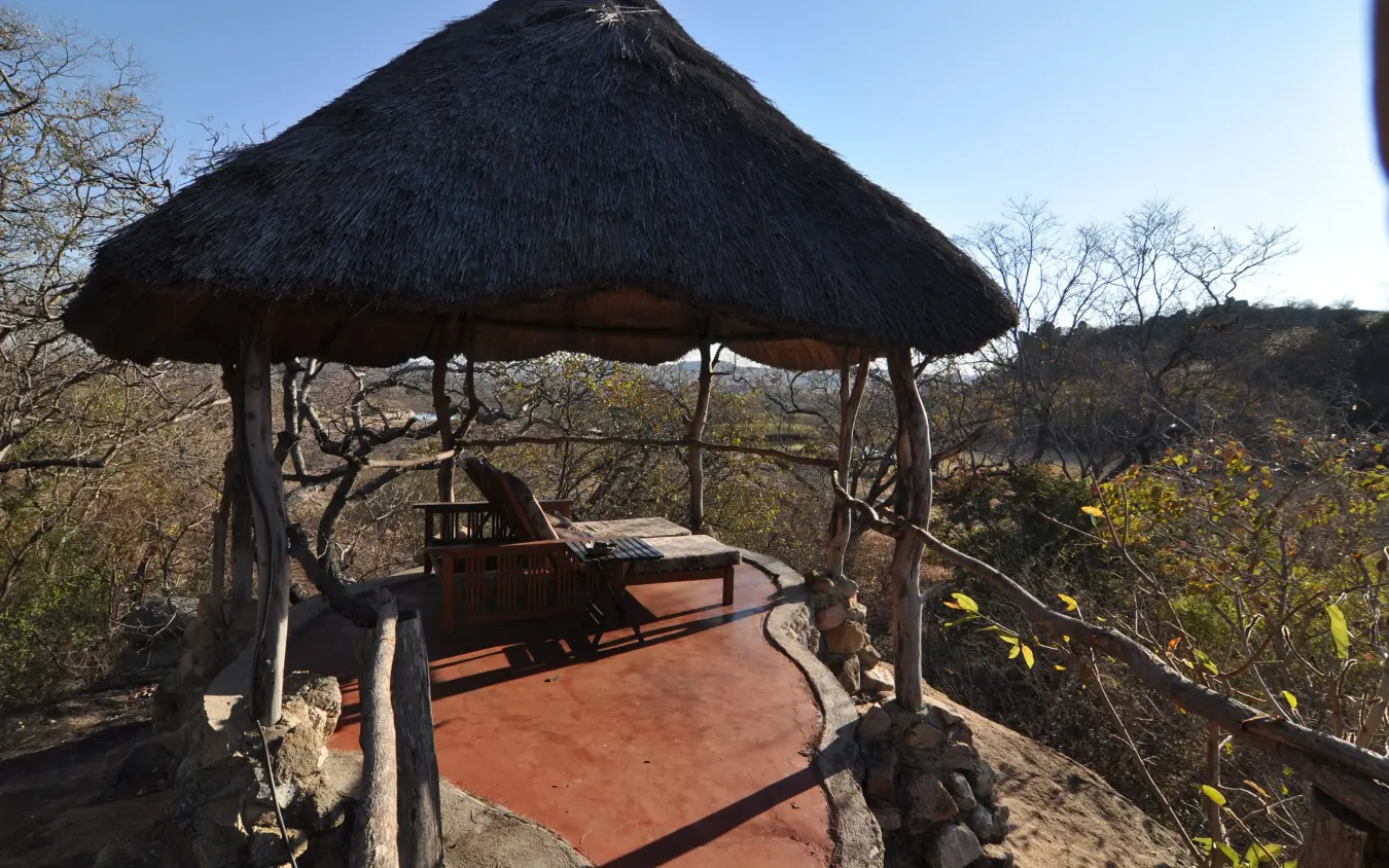 Thatched roof gazebo overlooking savanna landscape, Amalinda Lodge, Matobo, Zimbabwe