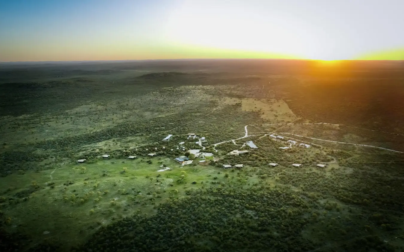 Aerial view of lodge nestled in savanna landscape at sunset, Anderssons at Ongava, Etosha National Park, Namibia