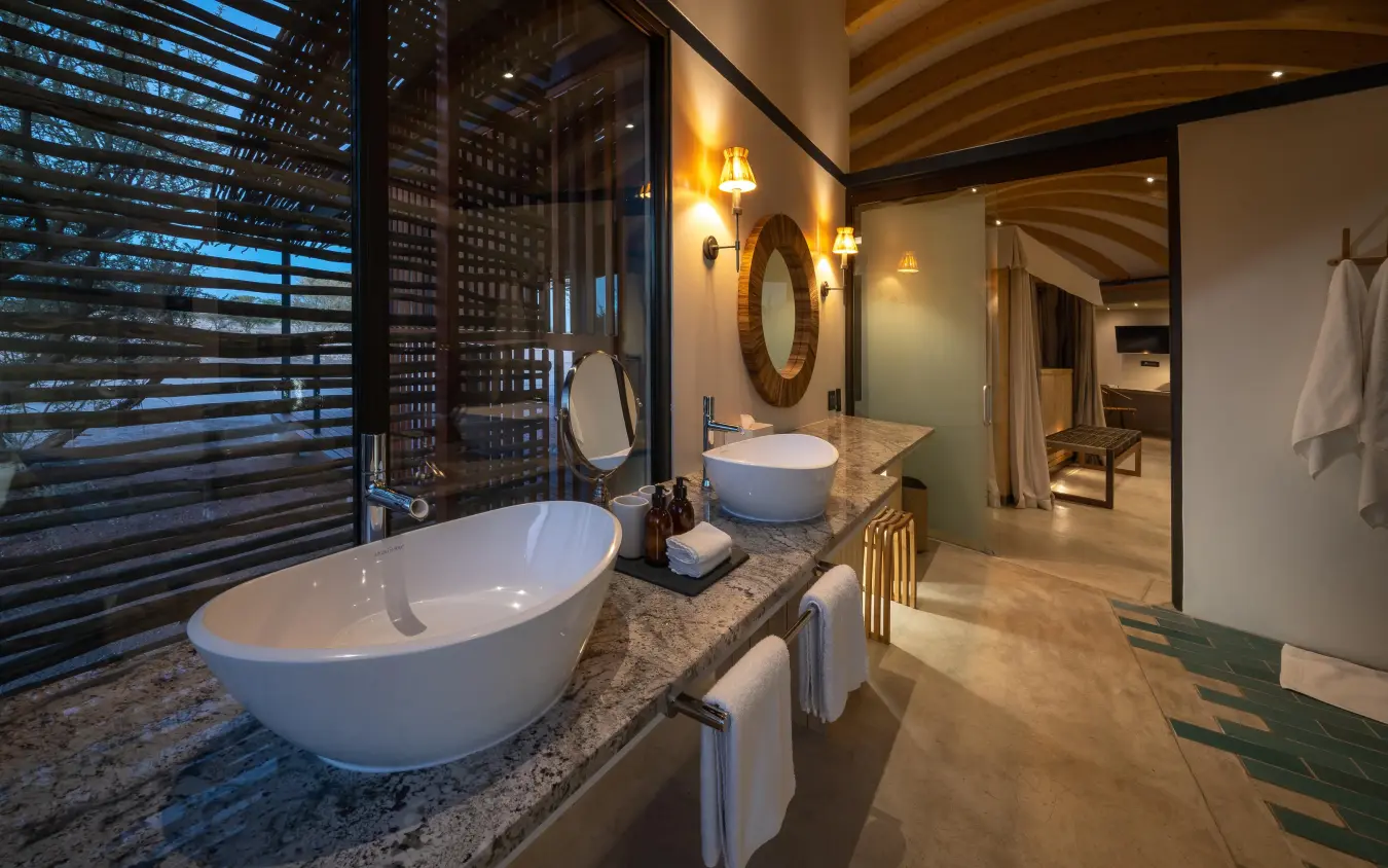 Luxury bathroom with dual vanities and freestanding tub, Anderssons at Ongava, Etosha National Park, Namibia