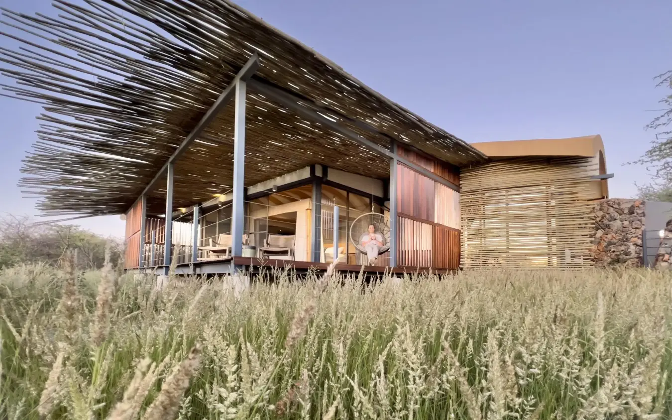 Contemporary wooden lodge structure in savanna grassland setting, Anderssons at Ongava, Etosha National Park, Namibia