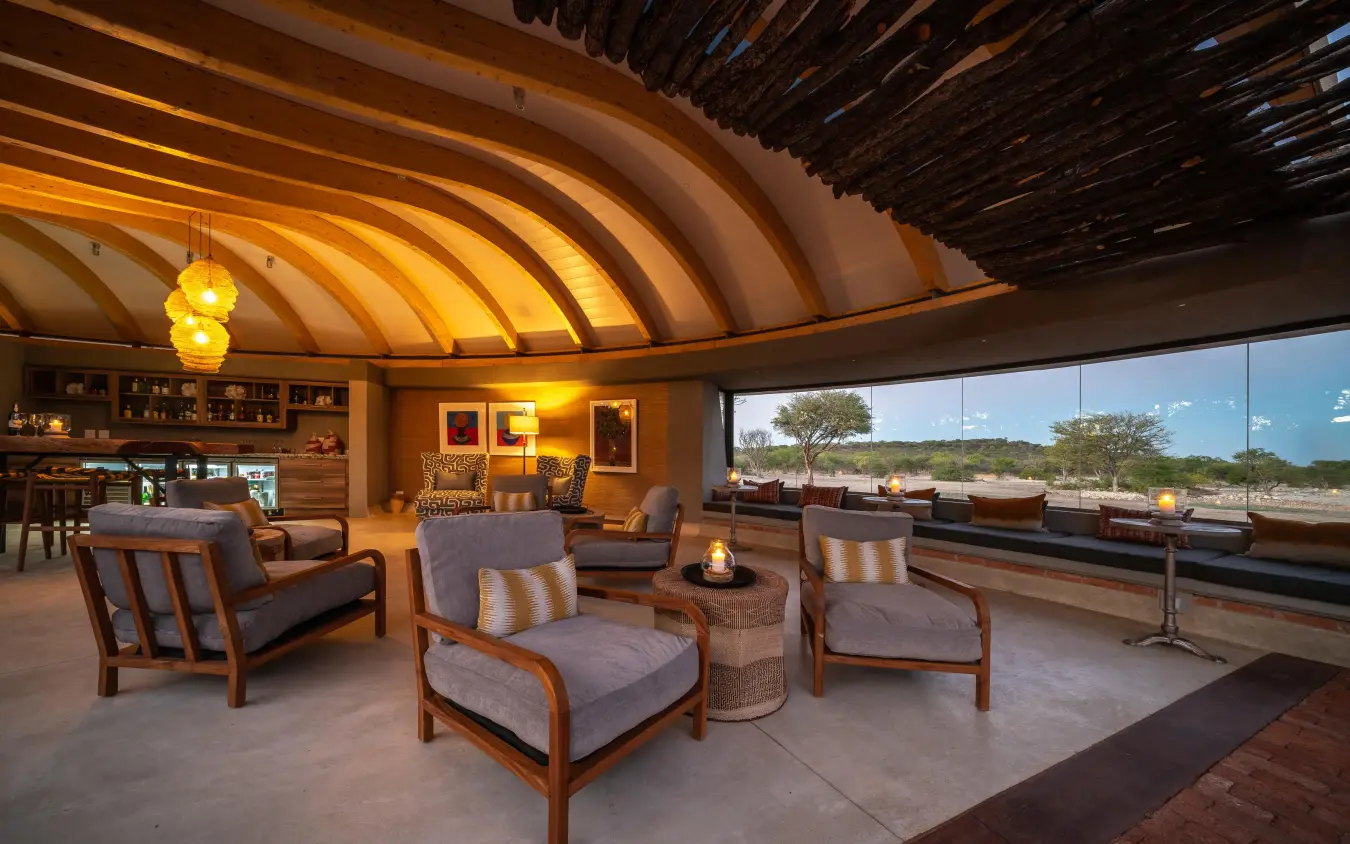 Modern lounge with curved wooden ceiling and landscape views, Anderssons at Ongava, Etosha National Park, Namibia