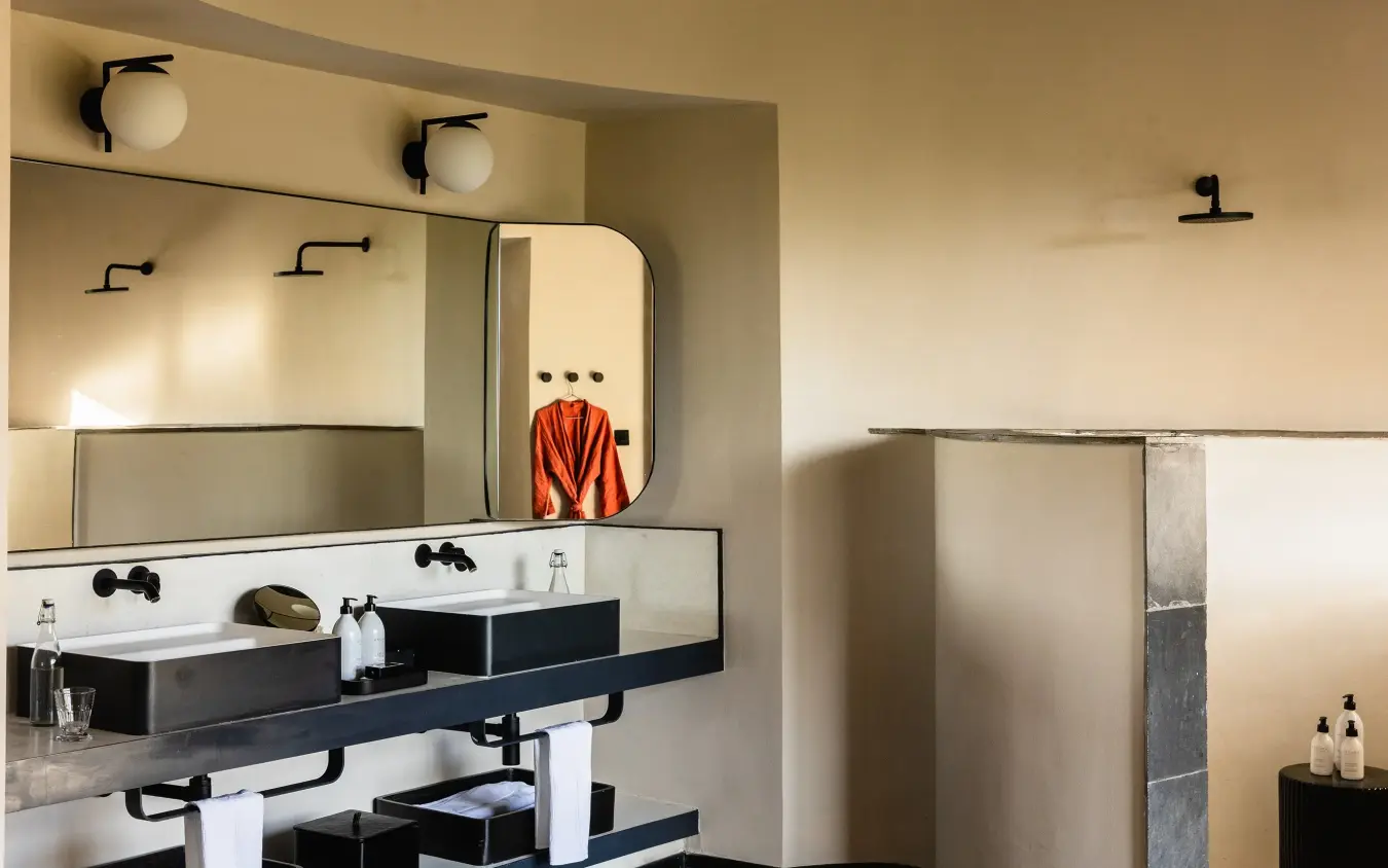 Modern bathroom vanity with dual sinks and black fixtures, Angama Amboseli, Amboseli and Chyulu Hills, Kenya