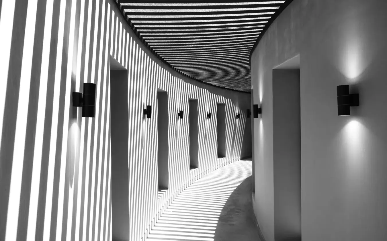 Modern corridor with linear wall panels and uplighting in contemporary interior, Angama Amboseli, Amboseli and Chyulu Hills, Kenya