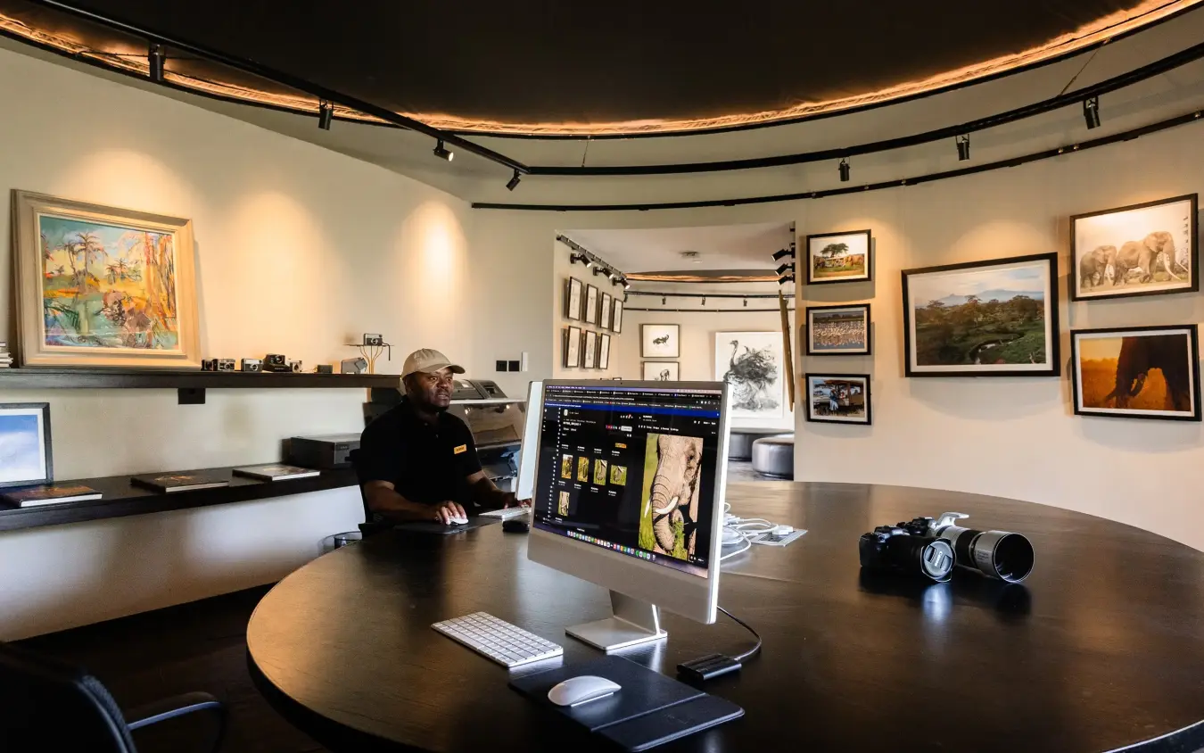 Modern office interior with wildlife photography gallery and professional workstation, Angama Amboseli, Amboseli and Chyulu Hills, Kenya