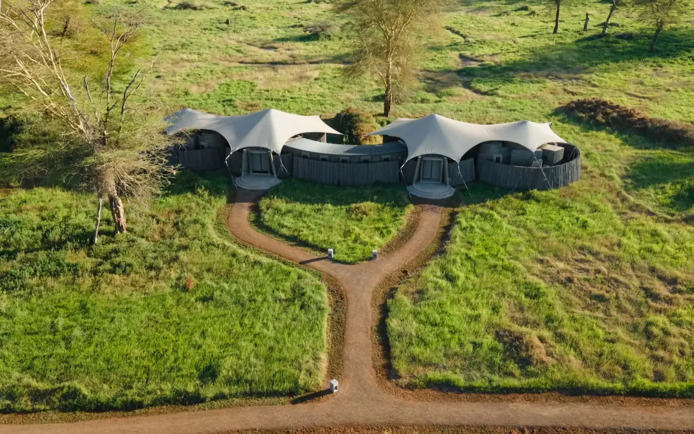 Aerial view of curved accommodation domes connected by pathways in green landscape, Angama Amboseli, Amboseli and Chyulu Hills, Kenya