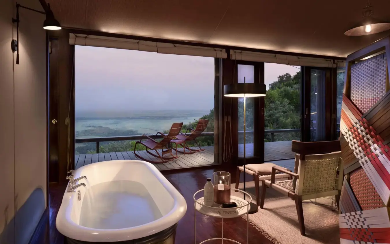 Luxury bathroom with soaking tub overlooking valley landscape, Angama Mara, Maasai Mara, Kenya