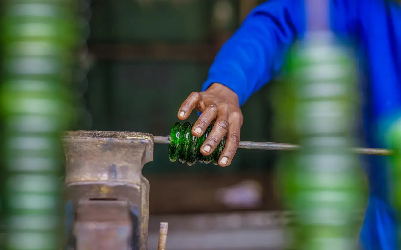 Artisan's hand working green metal at traditional forge, Arusha Coffee Lodge, Arusha, Tanzania