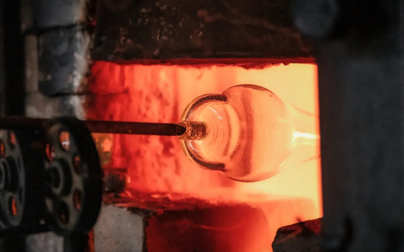 Blacksmith forging metal tool in glowing furnace, Arusha Coffee Lodge, Arusha, Tanzania